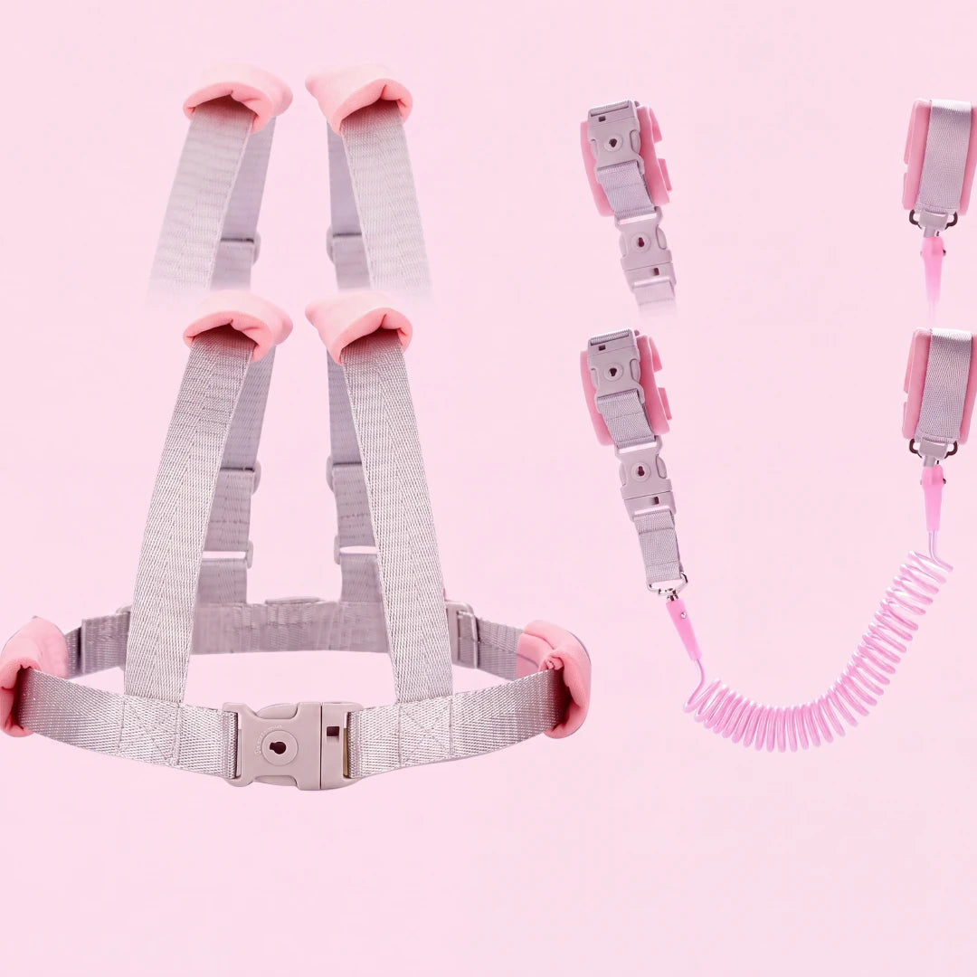 Toddler wearing the pink child safety harness with coiled leash, side view