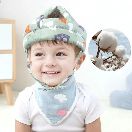 Smiling toddler wearing the green forest baby safety helmet, with a close-up of the soft cotton fabric